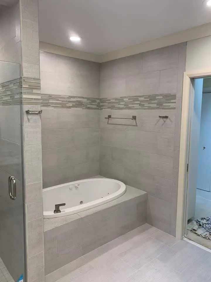 Completed bathroom with glass shower and soaking tub